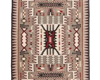 1083
Mabel Bighorse (B. 20th Century, Diné)
A Navajo Teec Nos Pos storm pattern textile, mid-20th century
Woven in wool grey, cream, brown, red, and black handspun wool in an elaborate storm pattern with a stepped sawtooth border
74.25" H x 50.5" W
Estimate: $800 - $1,200