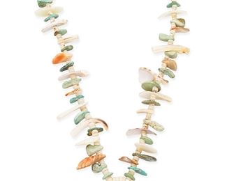 1087
Mid/late 20th century
A Pueblo Turquoise And Shell Necklace
A single strand necklace with various turquoise and carved shell tab and disc beads, with a central shell pendant with applied turquoise accents
25" L x 1.5" H
Estimate: $200 - $400