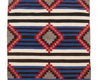 1092
Mid/late 20th century; Diné
A Navajo Revival Third Phase-Style Chief's Blanket
Woven in cream, dark brown, grey, blue, and red wool with three columns of stepped diamonds and alternating stripes of blue, black and cream
46" H x 46" W
Estimate: $500 - $700
