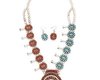 1107
Mid/late 20th century
A Set Of Southwest Petitpoint Turquoise And Coral Jewelry
Each appears unmarked
A Zuni-style two-sided reversible squash blossom necklace with cluster set and row set petit point turquoise to one side and set coral verso (25.5" L x 2.5" H), together with a pair of matching two-sided earrings (each: 1.75" H), 3 pieces
144.9 grams gross
Estimate: $600 - $900