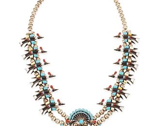 1108
Mid/late 20th century
A Zuni Sterling Silver And Stone Inlay Squash Blossom Necklace
Stamped: Sterling
A squash blossom style necklace with multistone inlay including turquoise, onyx, coral, and mother of pearl, with a bird motif naja, and twelve bird blossoms on a double-strung silver beaded necklace
28" L x 3" H
147.1 grams gross
Estimate: $500 - $700