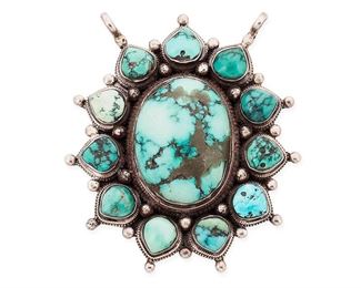 1110
Mid/late 20th century
A Southwest Sterling Silver And Turquoise Pendant
Stamped: 925
A large oval central cabochon turquoise stone with heavy matrix surrounded by eleven similar smaller teardrop stones, with smaller cabochon to reverse
3" H x 2.75" W
104.0 grams gross
Estimate: $200 - $300