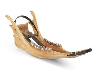 1117
Early/mid-20th century
An Inuit Caribou Jawbone Miniature Sled
A miniature sled formed from a caribou jawbone, with whale baleen struts and handle, with a hide pouch suspended from the handle
4.375" H x 13" W x 4.25" D
Estimate: $100 - $200