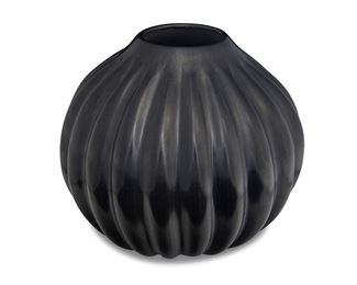1124
Helen Baca Shupla (1928-1985, Santa Clara Pueblo)
A blackware melon vessel
Signed to base: Helen Shupla / Santa Clara Pueblo
The large globular "melon" or "squash," jar with ridges and an overall burnished black slip glaze
8.5" H x 9.25" Dia.
Estimate: $1,500 - $2,500