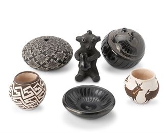 1127
A Group Of Southwest Native American Ceramics
Six works:

Dorothy and Paul Gutierrez
(b. 1940, Diné and b. 1940, Santa Clara Pueblo)
A blackware seated mudhead
Signed: Dorothy / Paul
With burnished olla and facial features
3.125" H x 1.625" W x 1.75" D

Crucita (Blue Corn) Gonzales Calabaza
(1921-1999)
A diminutive blackware bowl
Signed: Blue Corn / San Ildefonso Pueblo
With slip-painted feather motif on a burnished black slip glaze
0.875" H x 3" Dia.

Grace Medicine Flower
(b. 1938, Santa Clara Pueblo)
Avanyu serpent seed pot, 1981
Signed and dated: Grace Medicine Flower / 81 / [flower cipher]
The burnished blackware seed pot with sgraffito carved Avanyu serpent surrounded by deeply carved band
2.75" H x 3" Dia.

Marie Zieu Chino
(1907-1982, Acoma Pueblo)
Two white ceramic jars
One signed: Marie Z. Chino / Acoma N.M; another signed: M. Z Chino / Acoma
One with polychromed deer figures with heart lines, one with step design, 2 pieces
Larger: 2" H x 2.125" Dia.

An Acoma Pueblo see