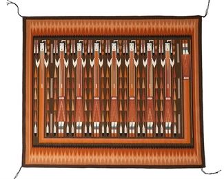 1140
Etta Peacock (B. 20th Century; Diné)
A Navajo Yei textile, late 20th/21st century
Woven in brown, rust, orange, cream, black, and blue wool, with seven Yei dancers and a rainbow guardian, with an irregular sawtooth border
48" H x 53" W
Estimate: $2,000 - $3,000