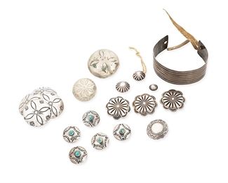 1147
Early/mid-20th century
A Group Of Native American Silver Items
Each appears unmarked
A German silver Plains Indian cuff bracelet pierced at terminals, with a leather cord (5.5" L x 0.875" H), together with a group of Southwest stamped silver metal buttons with metal shanks, in various sizes and patterns including a set of five stone set buttons and a group of silver buttons with chiseled designs (largest: 1.5" Dia.; smallest: 0.375" Dia.), 19 pieces
79.7 grams gross
Estimate: $300 - $500