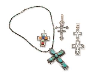 1148
Late 20th/21st century
A Group Of Southwest-Style Cross Pendants
Each variously marked for silver and for maker
Four works comprising a Don Lucas stone set sterling silver pendant (2.125" H x 1.5" W), an E.J. Bighand Navajo/Diné set turquoise and sterling silver cross with bead necklace (18.5" L x 3" H), a DBL silver double cross pendant with stampwork motifs (4" H x 1.375" W), and an LB cast sterling silver cross pendant (3.375" H x 1.5" W), 5 pieces
95.8 grams gross
Estimate: $200 - $400