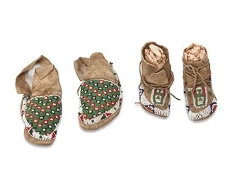 1166
Late 19th/ early 20th century
Two Pairs Of Plains Beaded Hide Moccasins
Comprising a pair of women's moccasins with green, red, black, and white patterned beadwork (7.5" L x 2.75" H x 3.25" W) and a pair of children's moccasins with beaded geometric motifs in white, green, red, blue, and silver beads (5.25" L x 3.25" H x 2.25" W), 4 pieces
Estimate: $400 - $600