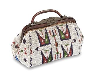 1168
Late 19th/early 20th century
A Sioux Beaded Doctor's Bag
The bag with fully beaded bag exterior with geometric and flag motifs in white, red, blue, and green beads, with a metal frame and handle, with a stiff pressed paper interlining and a purple striped open weave fabric lining
6.25" H x 12" W x 6" D; handle drop: 2"
Estimate: $3,000 - $5,000
