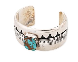 1176
Charlie John (B. 1954, Diné)
A Navajo sterling silver and turquoise cuff bracelet, late 20th/21st century
Stamped: CJ [for Charlie John] / Sterling
A silver overlay cuff with a shadowbox stepped mountain scene and a central bezel set turquoise stone
6.625" total inner C x 1.25" H, with a 1.25" gap
88.9 grams gross
Estimate: $400 - $600
