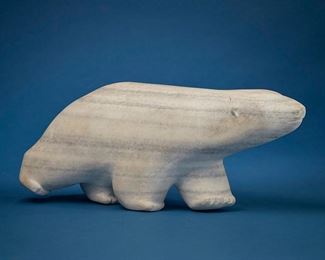 1210
Mikisiti Saila
1939-2008, Inuit; Cape Dorset/Kinngait
Carved Polar Bear Figure
Stone
Signed near bottom of foot: MEEKEESEETEE; further signed syllabically to underside with artist's disc number: E7-992
7.875" H x 19.75" W x 5.325" D
Estimate: $700 - $900