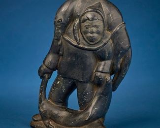 1222
Early/mid-20th century
An Inuit Carved Stone Figure
Attributed on partially illegible label to verso: P / [Peterossie] / Niss; with sticker to underside: Canadian eskimo art
Depicting a figure carrying a seal over their shoulder and at their feet
9.75" H x 6.5" W x 3" D
Estimate: $200 - $400
