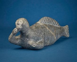 1227
Aliknak Parr
b. 1939, Inuit; Cape Dorset/Kinngait
Carved Figure Of Sea Spirit
Stone
Unsigned; marked with stickers to underside: A Parr / CD / Z84285
4.75" H 15.25" W x 3.75" D
Estimate: $200 - $400