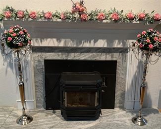 Faux floral decorations (Flowers by Joan). Mantel flowers are not a garland, but individual piece laid out to look like one. Wood stove not for sale.