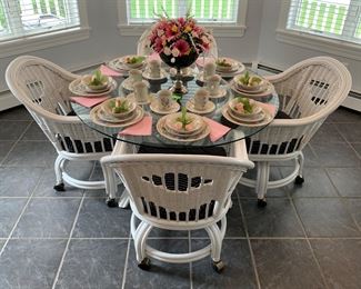 Bentwood, rattan and glass table and chairs on casters. 48” diameter. Pristine condition! Buyer must have help to load appropriate sized vehicle. 
Dinnerware set by Sango, “Primavera.” Forty pieces (no creamer/sugar). Floral posies included. 