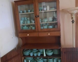 Antique hutch full of Fire King Jade-ite.  The cabinet and jade-ite is located at the 1898 home and available for sale June 3-4.