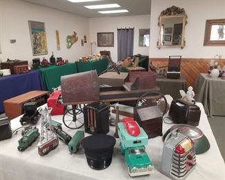 Old radios, Buddy L camper with boat, café juke box, old trains, antique soap box race car, old train cap, Mercury hubcap.  These items are located at the offsite location June1-4.