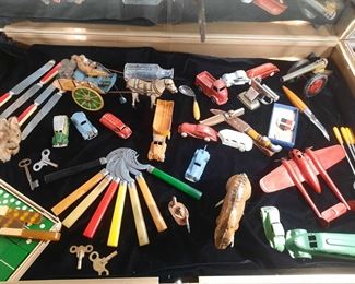 Bakelite utensils, a Bakelite domino set, antique toys.  This grouping is located offsite and available for sale June 1-4.