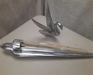 Vintage 1947 Chevy low rider hood ornament and 1940's chrome swan hood ornament which are located offsite and available June 1-4.
