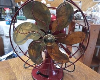 1930's Red Emerson fan with brass blades in good working order.  This fan is located offsite and available June 1-4.