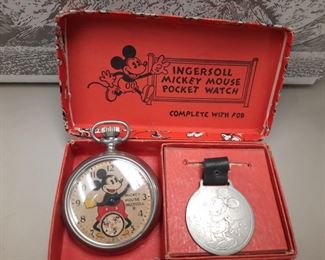 An original1933 Mickey Mouse pocket watch with fob and box.  This item is located at the offsite location June 1-4.