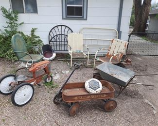 Vintage items located at the 1898 home in Colorado Springs, 80903 including a Ford hubcap, railroad light, metal bed frames, galvanized wheelbarrow.  Available June 3-4.