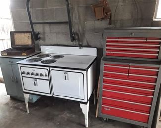 Art Deco Monarch stove, tool cabinet, vintage enamel cabinet, trailer hitch are all located in the garage at the 1898 home and available June 3-4.