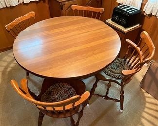 Dining table with two leaves (not shown) and four S. Bent & Bros. Chairs.
