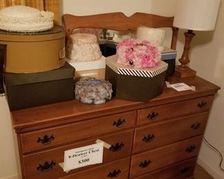 Maple chest with vintage hats on top.