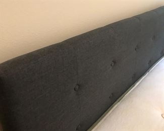 2 identical gray upholstered headboards and bed frames.  They also have under the bed storage.