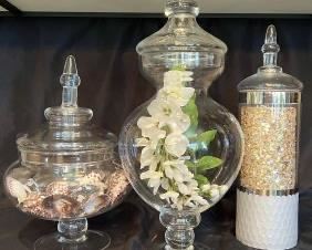 SET OF THREE MATCHED DECORATIVE GLASS URNS FILLED WITH SHELLS, FLOWERS AND A CANDLE!