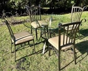 ELEGANTLY SCALLOPED GLASS TABLE WITH FOUR CAST ALUMINUM CHAIRS