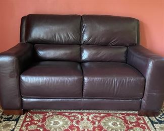 Leather Upholstered Loveseat. Measures approximately 68” W x 40” D. 