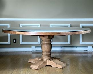 RESTORATION HARDWARE RUSTIC DINING TABLE | RH "French Farmhouse" in Dry Oak, nice light color with a conforming glass top; top comes off (via 4 bolts) for moving. - h. 31 x dia. 72 in

*Please bring a proper vehicle for moving this table; local delivery available contact the Auction Manager to inquire