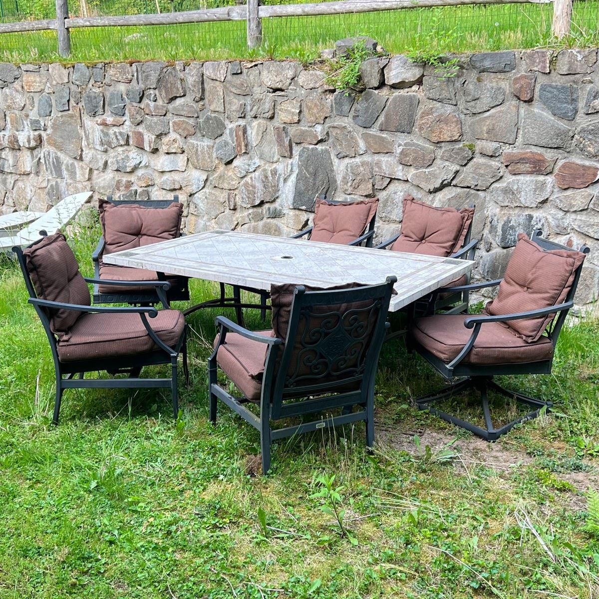 (7PC) PATIO TABLE & CHAIRS | Outdoor dining and lounge suite by Martha Stewart, black aluminum arm chairs with spring seats, cushions, and a white stone tile-top table. - l. 74 x w. 42 x h. 26 in