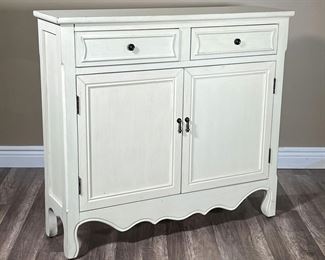 WHITE SOLID WOOD CABINET | White painted wood having two drawers over double cabinet doors, with a scalloped apron. - l. 40 x w. 11 x h. 36 in