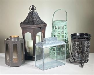(5PC) LANTERN GROUP | Including:
Wooden lantern with dark metal top and 3 candles
Round wood with green paint
A 6-sided metal lantern with punching decoration
A galvanized finish lantern of rectangular shape
An amber/clear crackle glass vase / candle holder in an iron black stand. - h. 22 x dia. 11 in (Largest is Wood Lantern with dark metal top)