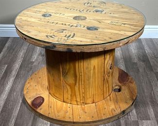 RUSTIC SOUTHWIRE SPOOL TABLE | Rustic wire spool form table painted with company logo and name “Southwire” with custom glass top. - h. 20.5 x dia. 30 in