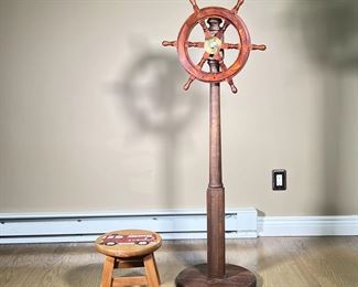 (2PC) MISC. DECOR | Including a small free spinning ship wheel on wooden stand and small children’s stool featuring a painted carving of a fire truck. - l. 15 x w. 15 x h. 54 in (largest)