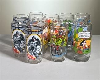(12PC) MCDONALD'S PROMOTIONAL GLASSES | Glasses feature: Mrs. Piggy and other Muppets from The Muppets Great Caper, The Smurfs, Charlie Brown, and King Kong. - h. 6 x dia. 2.75 in