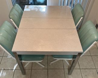 kitchen table & 4 swivel chairs on wheels... needs a Mr. Eraser.. but otherwise good condition!