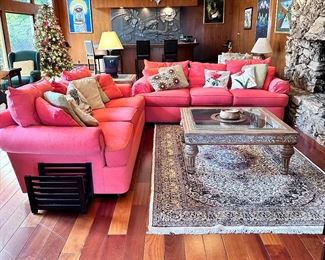 Two coral 3 cushion sofas. Art you see on walls in background will not be for sale.