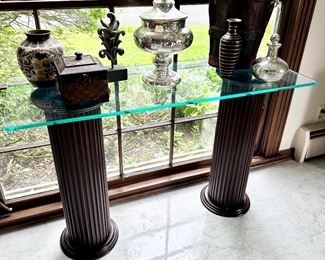 Fluted wood columns with glass top table.