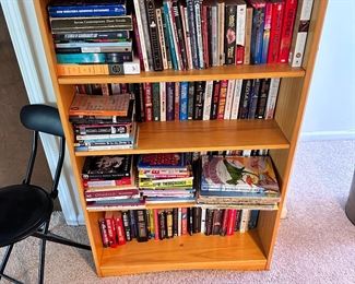 Many bookshelves and books for sale.