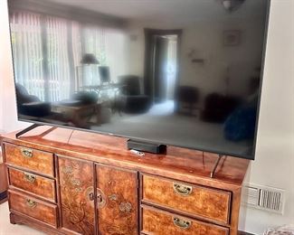 LARGE flatscreen television and matching Asian style dresser.