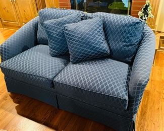 Like new! Blue upholstered double cushion loveseat with two throw pillows