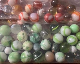 Marbles in shades of green, orange, and red…