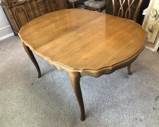 Dining room table. It has three leaves, each one a foot wide. They are darker than the rest of the table because they have spent most of their lives in a closet. 
