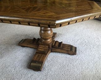 Another view of the table with its single pedestal. Notice the design along the edges, matching the other two pieces in the set.